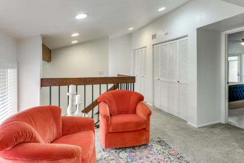 a living room with two orange chairs and a rug at 5 Mi to Colorado River Yuma Gem with Pool Access! in Yuma
