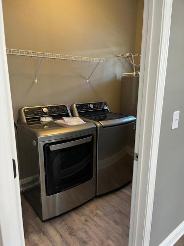 a small kitchen with a stove and a refrigerator at Gateway To The Gulf in Pensacola