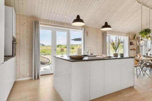 a kitchen with a white island in a room at LN1985-Hjorring-Kystvejen-125 in Hjørring