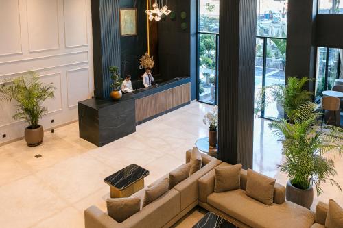 a lobby with couches and plants in a building at NearYo Hotels in Marrakech
