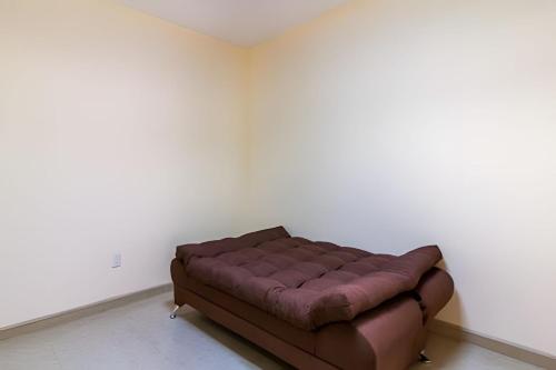 a brown leather couch in a white room at Cheerful residential house in the heart of Chapala in Chapala