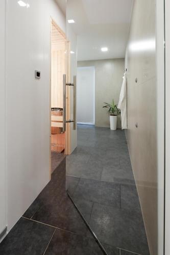 a hallway with a door and a tile floor at SPA Apartment Adriatico in Rijeka