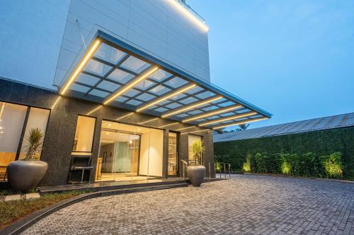 a building with a large window with lights on it at Park Inn & Suites by Radisson Thrissur East Fort in Trichūr