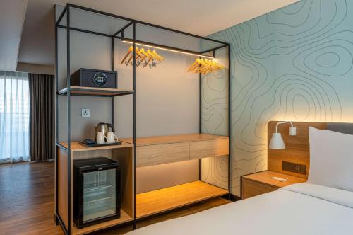 a hotel room with a bed and a room with a room at Park Inn & Suites by Radisson Thrissur East Fort in Trichūr