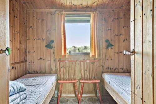 two chairs in a room with a bed and a window at LN76102-Hjorring-Kystvejen-116 in Hjørring