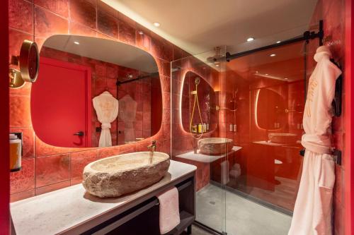 a bathroom with two sinks and a large mirror at Nhow Lima in Lima