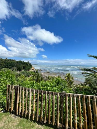 a wooden fence looking out at the beach at Hosteria Cumilinche in Same