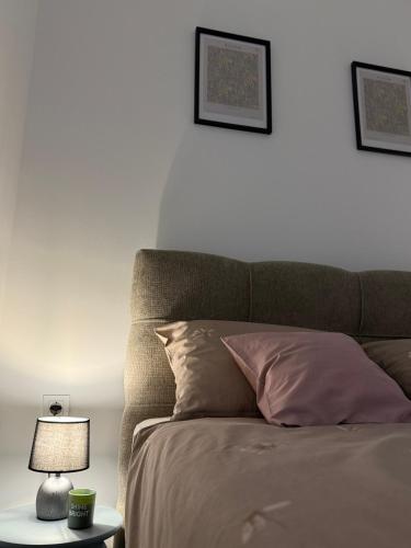 a bedroom with a bed and a table with a lamp at Apartman Dukat- Luksuzna novogradnja u srcu Vinkovaca s parkingom in Vinkovci