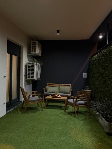 a living room with two chairs and a table at Apartman Dukat- Luksuzna novogradnja u srcu Vinkovaca s parkingom in Vinkovci