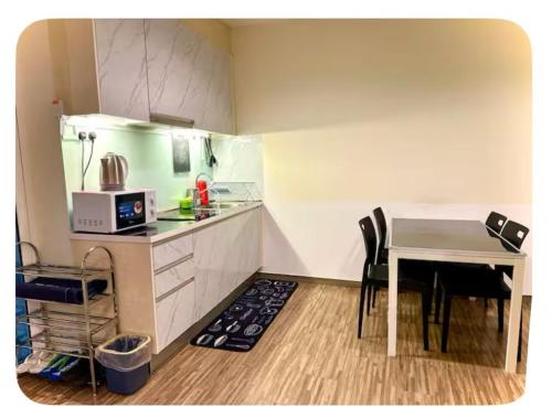 a small kitchen with a table and a counter top at Setapak Central Mall Bathtub & Netflix in Kuala Lumpur