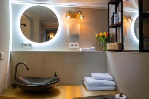 a bathroom with a black bowl sink and a mirror at Houseboat Reussi in Amsterdam