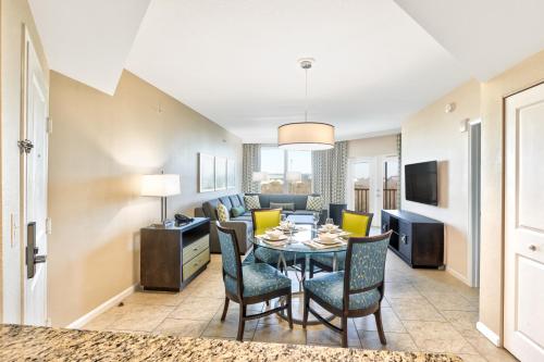 a dining room and living room with a table and chairs at Vacation Village at Parkway in Orlando