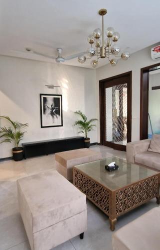 a living room with a couch and a coffee table at 4 BR Luxury & Modern Full Home in DHA Phase 6 in Lahore