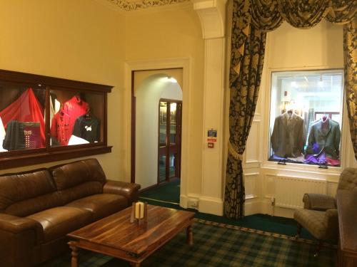a living room with a couch and a table at Mansfield House Hotel in Hawick