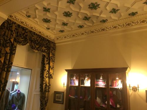 a living room with a coffered ceiling and a closet at Mansfield House Hotel in Hawick