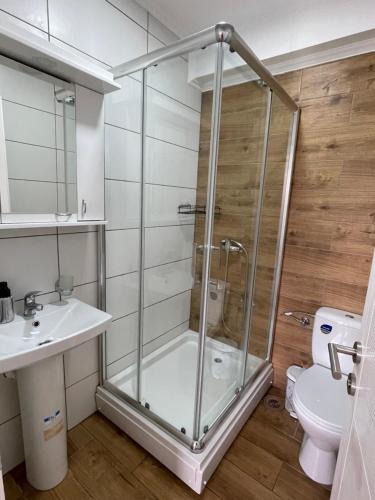 a bathroom with a shower and a sink and a toilet at Stojicic ROYAL in Vrnjačka Banja