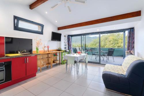 a kitchen and living room with a couch and a table at Gîte F2, Dans Un Coin De Paradis in Céret