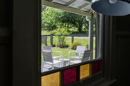 a group of chairs sitting on a porch at Bobby's Country Rental in Eccleston
