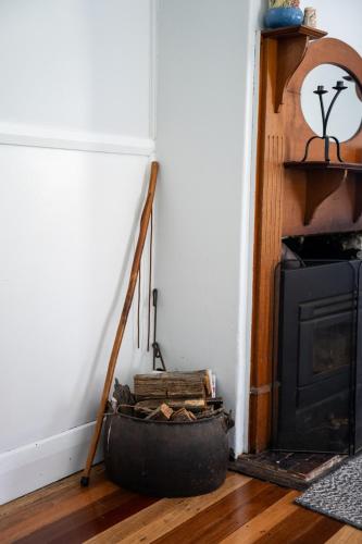 a room with a staircase and a black stove at Bobby's Country Rental in Eccleston