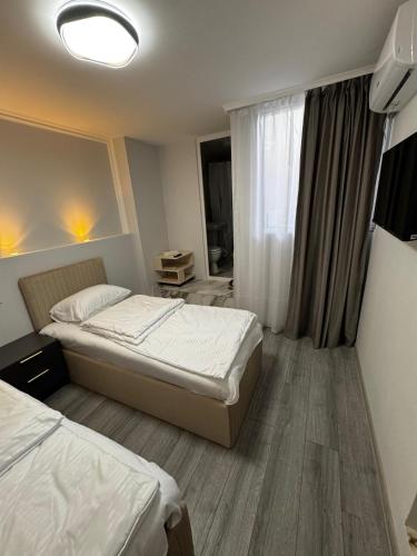 a hotel room with two beds and a window at Station House EVN in Yerevan