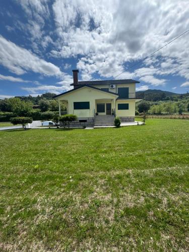 a house on a field with a large yard at House Santiago in Ponte de Lima in Ponte de Lima