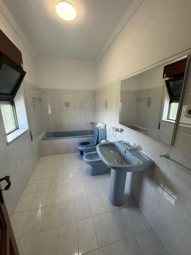 a bathroom with two toilets and a sink and a tub at House Santiago in Ponte de Lima in Ponte de Lima