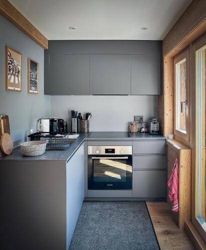 a kitchen with gray counters and a stove top oven at The Mazot in Nendaz