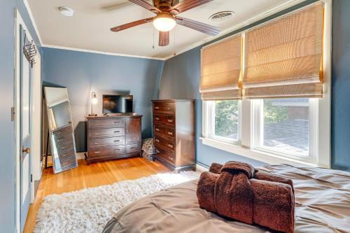 a bedroom with a bed and a dresser and windows at Lake Geneva Family Gem with Fenced Dog Run! in Lake Geneva