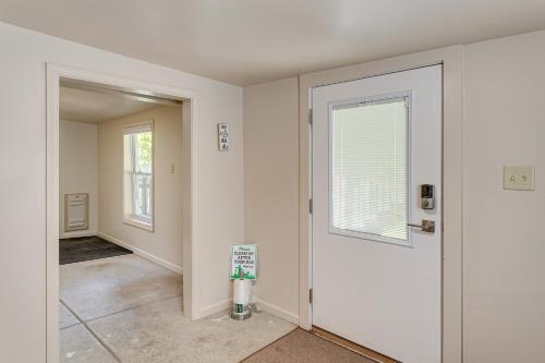 an empty hallway with a door and a window at Lake Geneva Family Gem with Fenced Dog Run! in Lake Geneva