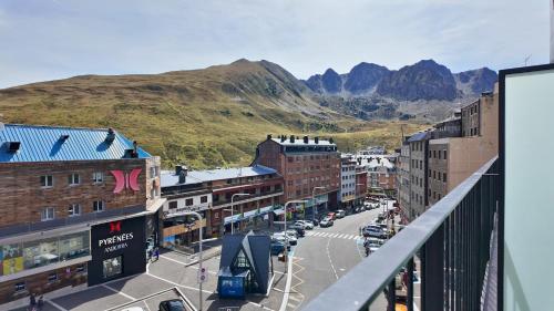 a view of a city with a mountain in the background at Hotel Focus in Pas de la Casa