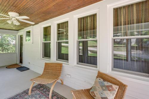 a porch with two chairs and a ceiling fan at Lake Geneva Family Gem with Fenced Dog Run! in Lake Geneva