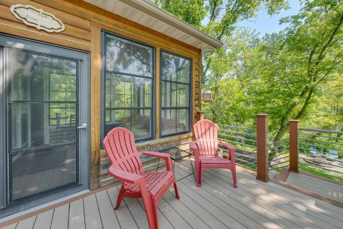 two red chairs and a table on a porch at Lake Geneva Family Gem with Fenced Dog Run! in Lake Geneva