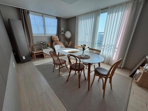 a living room with a dining room table and chairs at Breeze Blows House, Incheon in Towŏn-yŏk