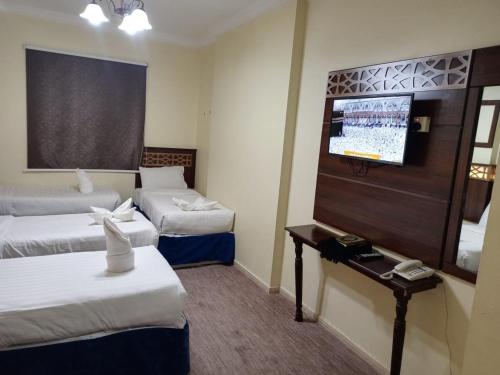 Postel nebo postele na pokoji v ubytování فندق العليان الفضي Olyaan Silver Hotel