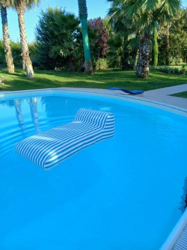 a blue swimming pool with a white swirl on it at L'introvabile in Cesena
