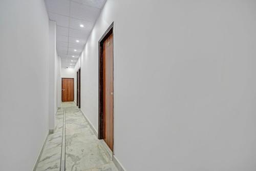 an empty corridor with a door in a building at HOTEL O SMALL TOWN in New Delhi