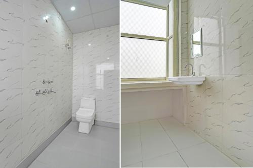a bathroom with a toilet and a sink and a window at HOTEL O SMALL TOWN in New Delhi