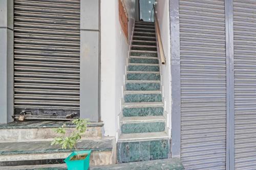 a set of stairs leading up to a building at HOTEL O SMALL TOWN in New Delhi