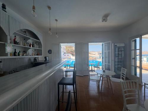 a bar in a restaurant with chairs and tables at Golden Sun in Ios Chora