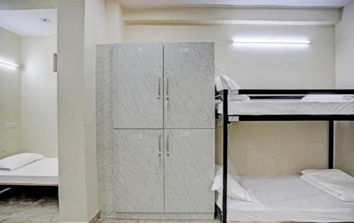 a room with two bunk beds and a closet at Hotel SB Grand Inn - Paharganj in New Delhi