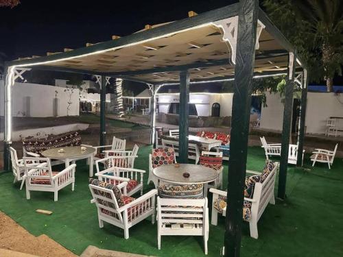 a group of tables and chairs under a pavilion at فندق جرين فالي دهب - Green Valley Hotel in Dahab