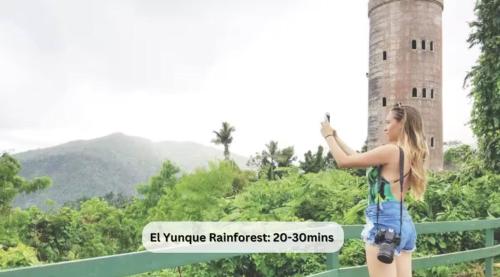 a girl taking a picture of a tower at OCEAN FRONT Paradise with Pool in Las Croabas
