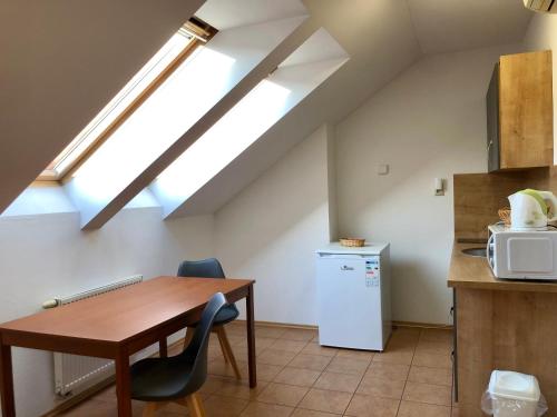 a kitchen with a wooden table and a window at Sejong Guest house - 세종게스트하우스 in Trnava