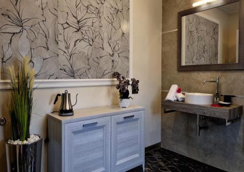 a bathroom with a sink and a mirror at Vi Ja Villa Janas Cagliari Resort in Cagliari