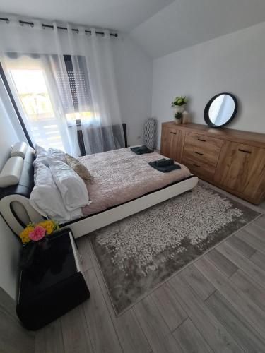 a bedroom with a bed and a large window at Diana in Hemeius