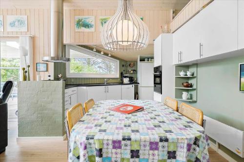 a kitchen with a table with a table cloth on it at LN719-Hjorring-Skagerakvej-7 in Hjørring