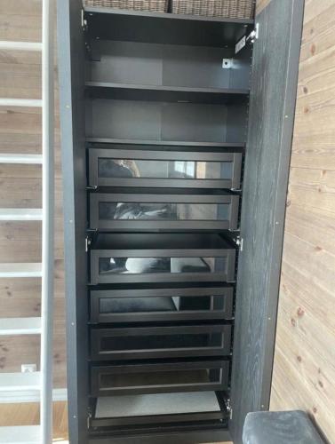 a closet with black drawers in a room at Mountain Cabin with Ski-in Access in Björnrike 