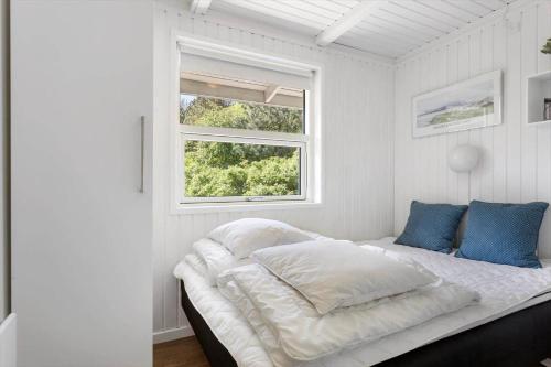 a white bed in a white room with a window at LN866-Hjorring-Ostersovej-34 in Hjørring
