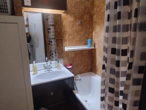 a bathroom with a sink and a tub and a shower at 1 Bedroom flat, 5 min walk funicular Les Arcs & in city center, Parking, Wifi in Bourg-Saint-Maurice