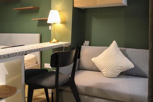 a living room with a couch and a table with a pillow at Studio 2 steps from the Musée Grévin in Paris